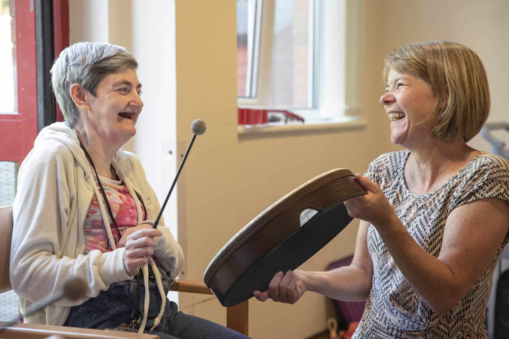 A music therapist and client making music together